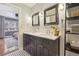 Bathroom with double vanity, marble countertops, and black framed mirrors at 4855 Knox Ct, Denver, CO 80221