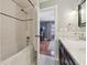 Bright bathroom featuring white subway tiles in the shower and a view of the Primary bedroom at 4855 Knox Ct, Denver, CO 80221