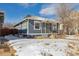 Blue house exterior with a snowy yard, showing the side of the house at 4855 Knox Ct, Denver, CO 80221