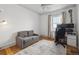 Bright home office with hardwood floors, gray couch, and natural light at 4855 Knox Ct, Denver, CO 80221