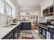 Modern kitchen with white and navy cabinets, stainless steel appliances, and quartz countertops at 4855 Knox Ct, Denver, CO 80221