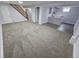 View of finished basement, carpeted living area, small kitchenette, and staircase to upper level with wood railing at 8947 Rutgers St, Westminster, CO 80031