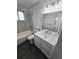 Bathroom featuring updated lighting, a vanity with a white countertop, and tiled walls at 8947 Rutgers St, Westminster, CO 80031