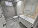 Bathroom featuring a white vanity, shower, toilet, modern fixtures, and stone details at 8947 Rutgers St, Westminster, CO 80031