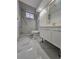 Modern bathroom featuring tiled shower with glass door, updated vanity, new fixtures, and neutral color palette at 8947 Rutgers St, Westminster, CO 80031