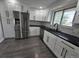 Kitchen featuring stainless steel appliances, white cabinets, and black countertops at 8947 Rutgers St, Westminster, CO 80031