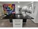 Bright kitchen featuring stainless steel appliances, white cabinets and a large center island at 8947 Rutgers St, Westminster, CO 80031