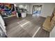 Spacious open floor plan of the living room and kitchen, with a colorful wall mural and fireplace at 8947 Rutgers St, Westminster, CO 80031