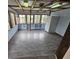 Bright sun room with many windows, built-in shelving, and tile floors at 8947 Rutgers St, Westminster, CO 80031