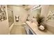 Well-lit bathroom with tiled floor, shower-tub combo, and floral decor at 7695 E Quincy Ave # 207, Denver, CO 80237