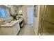 A well-lit bathroom with ample counter space, vanity, and shower at 7695 E Quincy Ave # 207, Denver, CO 80237