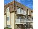 Multi-story condo building featuring private balconies and unique roof design at 7695 E Quincy Ave # 207, Denver, CO 80237
