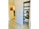 Hallway with closet, open shelving, and tile flooring at 7695 E Quincy Ave # 207, Denver, CO 80237