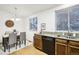 Kitchen with granite countertops, dark wood cabinets, and black appliances at 8546 Willows Pl, Parker, CO 80134