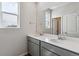 Bright bathroom featuring a double sink vanity with a large mirror at 14145 Deertrack Ln, Parker, CO 80134