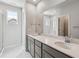 Bright bathroom featuring a double sink vanity with a large mirror and a separate shower area at 14145 Deertrack Ln, Parker, CO 80134