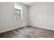Minimalist bedroom with hardwood floors and a window providing natural light at 14145 Deertrack Ln, Parker, CO 80134