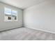 Comfortable bedroom featuring a large window and soft neutral carpet at 14145 Deertrack Ln, Parker, CO 80134