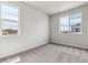 Light filled bedroom with two windows and neutral carpet at 14145 Deertrack Ln, Parker, CO 80134