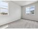 Spacious bedroom with soft carpet and two large windows offering plenty of natural light at 14145 Deertrack Ln, Parker, CO 80134