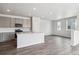 Spacious kitchen with island, stainless appliances and grey cabinets and opens to the living room at 14145 Deertrack Ln, Parker, CO 80134