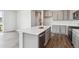 Bright kitchen island with stainless appliances and quartz counters provides a gathering spot at 14145 Deertrack Ln, Parker, CO 80134