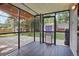 Relaxing screened in back porch features a patio and lush backyard, great for outdoor entertaining and enjoying serene views at 7650 W 24Th Ave, Lakewood, CO 80214