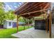 Beautiful backyard featuring a wooden pergola, green lawn, and storage shed at 7650 W 24Th Ave, Lakewood, CO 80214