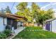 Spacious backyard with a charming patio area and lush lawn, complete with additional storage sheds at 7650 W 24Th Ave, Lakewood, CO 80214