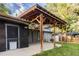 Charming backyard featuring a covered patio area, lush greenery, and a privacy fence at 7650 W 24Th Ave, Lakewood, CO 80214