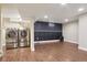Spacious basement with wood-look tile floors, a laundry area, and accent wall with LED lighting at 7650 W 24Th Ave, Lakewood, CO 80214
