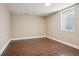 Empty basement room with tile floors, a window, and neutral-toned walls at 7650 W 24Th Ave, Lakewood, CO 80214