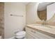 Well-lit bathroom featuring granite countertops, modern fixtures, and neutral-toned walls at 7650 W 24Th Ave, Lakewood, CO 80214