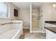 Well-designed bathroom with a separate tub and shower, tile floors and sleek fixtures at 7650 W 24Th Ave, Lakewood, CO 80214