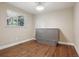 Charming bedroom features modern window, built-in Murphy bed, and wood-look floors at 7650 W 24Th Ave, Lakewood, CO 80214
