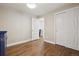 Bright bedroom showcasing hardwood floors, open doorway, and abundant closet space at 7650 W 24Th Ave, Lakewood, CO 80214