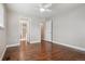 Spacious bedroom with hardwood floors, white trim, and access to the bathroom at 7650 W 24Th Ave, Lakewood, CO 80214