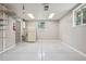 Organized garage with epoxy flooring, built-in shelving, and great natural light at 7650 W 24Th Ave, Lakewood, CO 80214