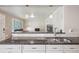 Beautiful kitchen with granite countertops, stainless steel sink, and modern lighting fixtures at 7650 W 24Th Ave, Lakewood, CO 80214