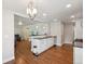 Spacious open concept kitchen with a large island, stainless steel appliances, and hardwood floors at 7650 W 24Th Ave, Lakewood, CO 80214