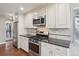 Modern kitchen features stainless steel appliances, white cabinets, and sleek countertops at 7650 W 24Th Ave, Lakewood, CO 80214
