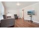 Open living area with hardwood floors, large window, sofa, and television at 7650 W 24Th Ave, Lakewood, CO 80214