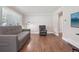 Spacious living room with hardwood floors, large window, and comfortable sofa at 7650 W 24Th Ave, Lakewood, CO 80214