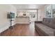 Inviting living room with open floorplan, hardwood floors and view to the kitchen at 7650 W 24Th Ave, Lakewood, CO 80214