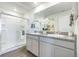 Bathroom with double vanity sinks, granite countertops, and a glass enclosed shower at 4204 Sandstone Dr, Mead, CO 80504