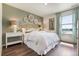 Bedroom with decorative wall hangings, neutral palette, and large windows at 4204 Sandstone Dr, Mead, CO 80504