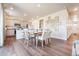 Open concept dining area with modern furnishings, a kitchen island, and elegant décor at 4204 Sandstone Dr, Mead, CO 80504