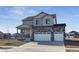 Charming two-story home with a three-car garage, stone accents and covered porch at 4204 Sandstone Dr, Mead, CO 80504