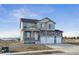 Charming two-story home with a three-car garage, stone accents and covered porch at 4204 Sandstone Dr, Mead, CO 80504