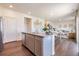 Open-concept kitchen with stainless appliances, island seating, flowing to the living room at 4204 Sandstone Dr, Mead, CO 80504